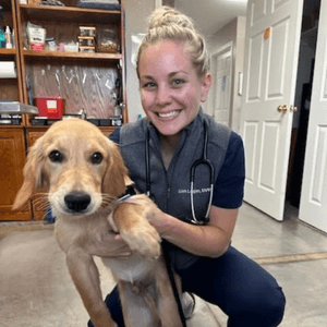 Dr. Logan affectionately  holding a dog